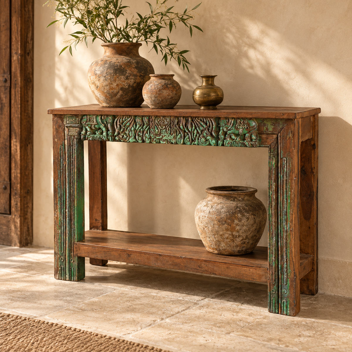 Styled green carved console table with antique pots